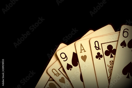 Playing cards on a dark background close up. Retro style