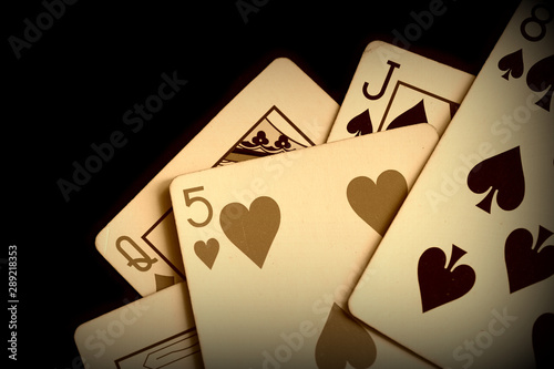 Playing cards on a dark background close up. Retro style