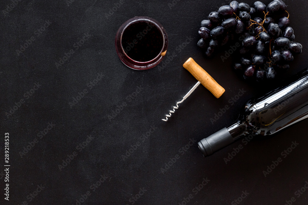 Composition with wine bottle on black background top view space for text