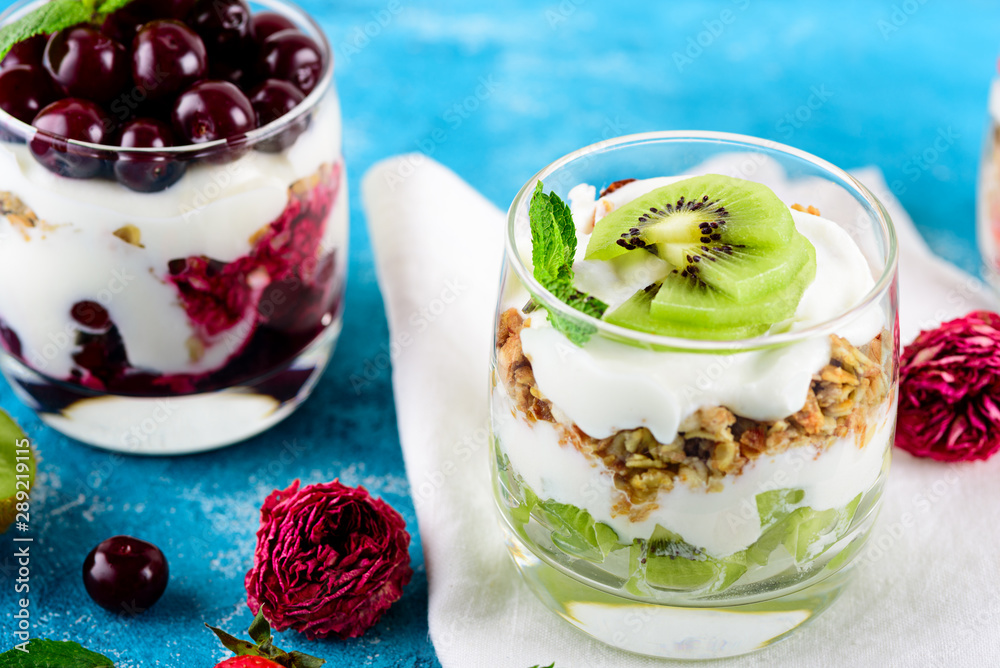 Vegan healthy Breakfast, dessert of ricotta, granola and kiwi, cherries Vegan healthy Breakfast, dessert of ricotta, granola and kiwi, cherries