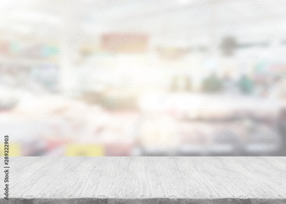 white wooden top with burred of shopping mall as a background white wooden top with burred of shopping mall as a background