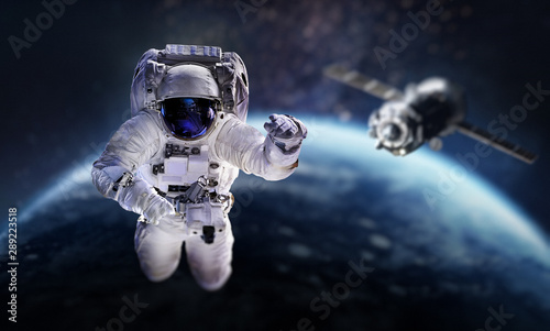 Fototapeta Naklejka Na Ścianę i Meble -  Astronaut in the outer space over the planet Earth. Space craft behind. Spaceship. Spaceman. Elements of this image furnished by NASA