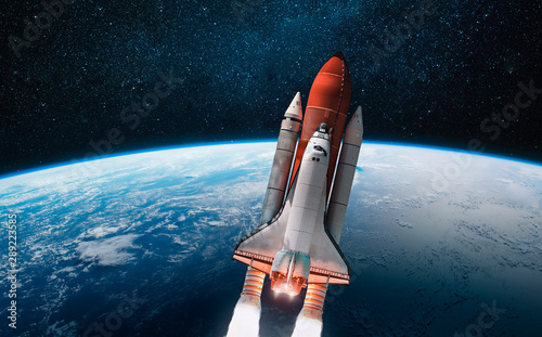 Fototapeta Naklejka Na Ścianę i Meble -  Space shuttle launch in outer space from Earth. Rocket on orbit of the planet. View from space station. Elements of this image furnished by NASA	