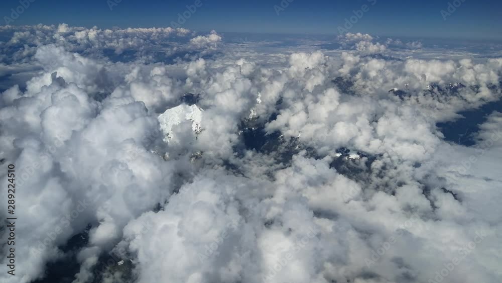 Aerial mountain view of snowy andes summit above clouds, south america Aerial mountain view of snowy andes summit above clouds, south america