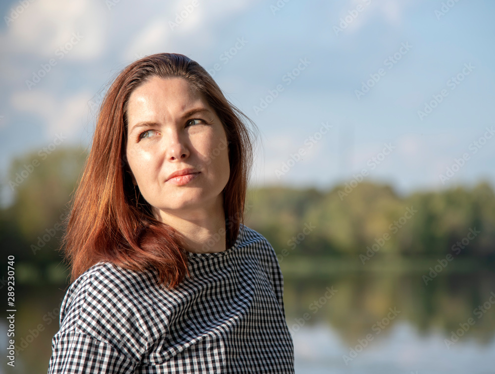 Portrait of a middle-aged woman in a plaid tunic Portrait of a middle-aged woman in a plaid tunic
