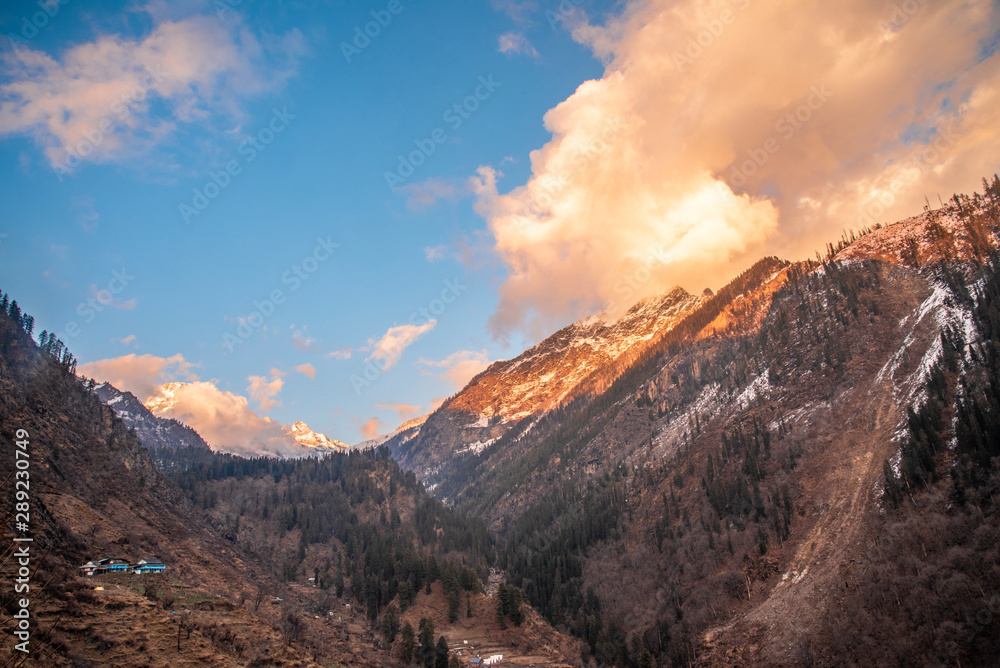 Fototapeta premium orange color sunset landscape with snow mountain