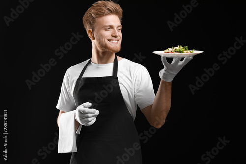 Handsome waiter with salad ...