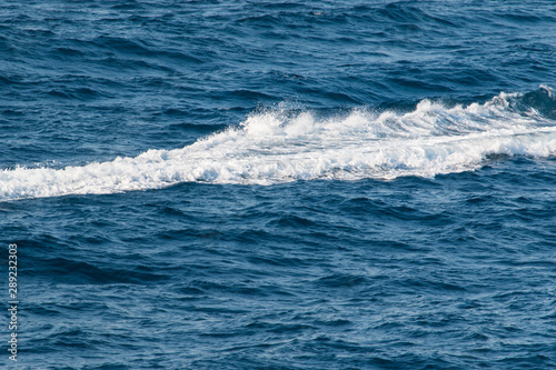 waves with foam on the sea as a background