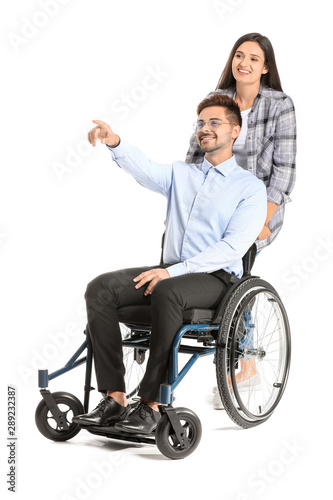 Young businessman in wheelchair and with wife on white background
