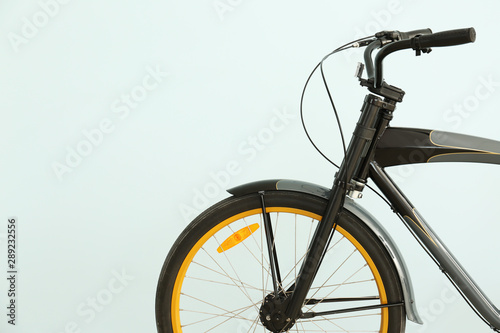 Modern bicycle on light col...