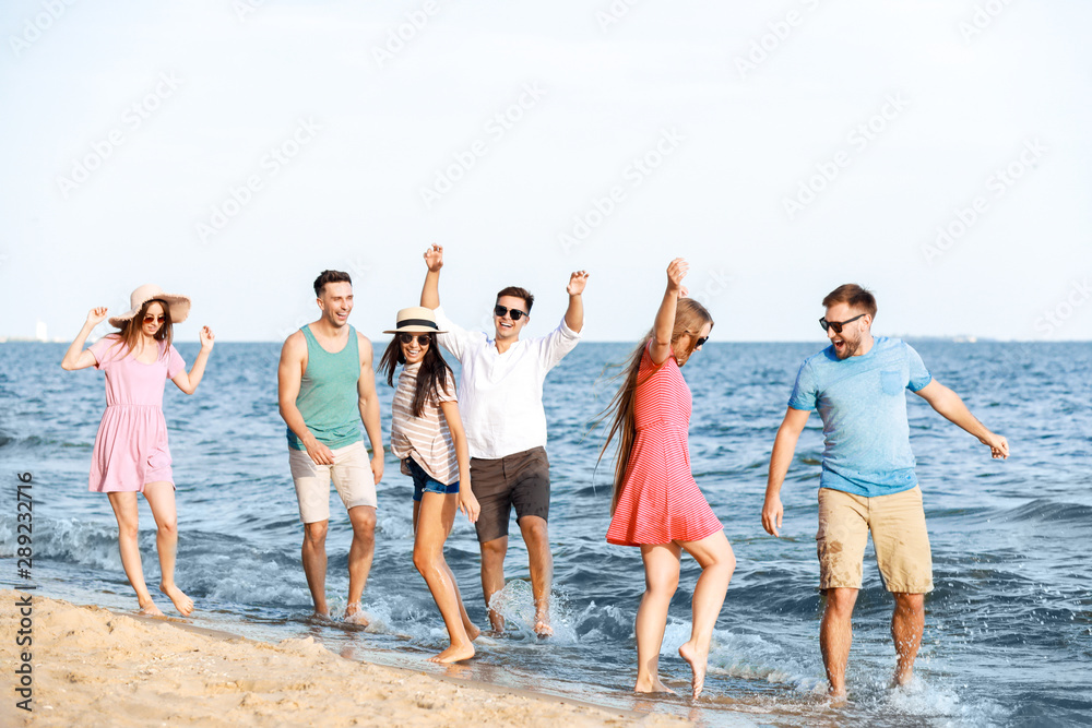 Fototapeta premium Happy friends on sea beach at resort