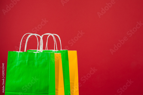 Arrangement of shopping bags on red background