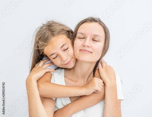 Happy family. Little girl embracing his mother at home