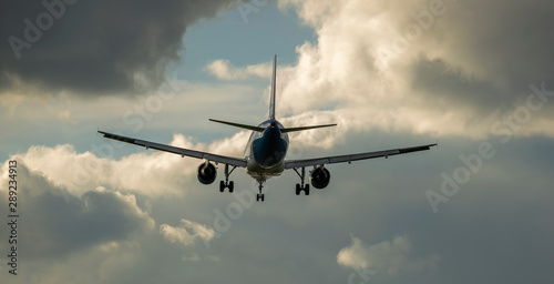 Photos passenger plane flies in thunderclouds in the sky.