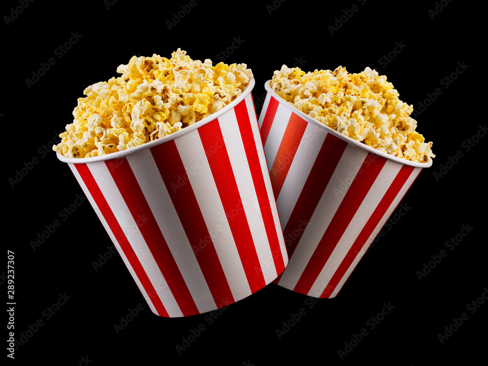 Set of paper striped buckets with popcorn isolated on black background Set of paper striped buckets with popcorn isolated on black background