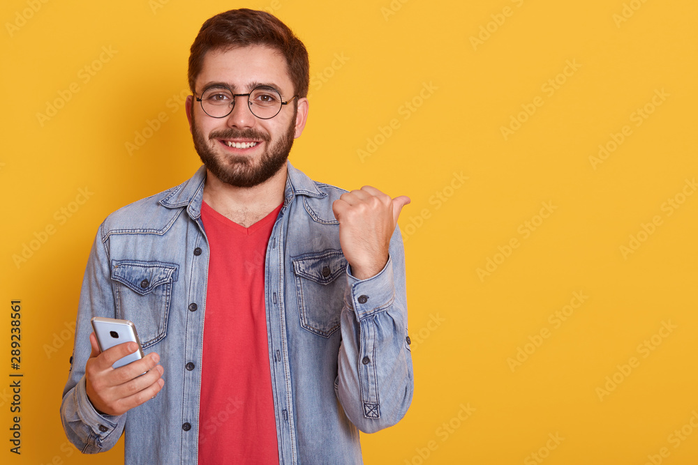Image of excited happy man expresses happiness, celebrates his great triumph and victory, clenches fists. Attractive male champion achieves big effective results,looking smiling directly at camera. Image of excited happy man expresses happiness, celebrates his great triumph and victory, clenches fists. Attractive male champion achieves big effective results,looking smiling directly at camera.