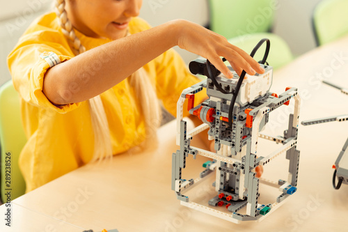 Wallpaper Mural Schoolgirl checking a robot she made in class. Torontodigital.ca