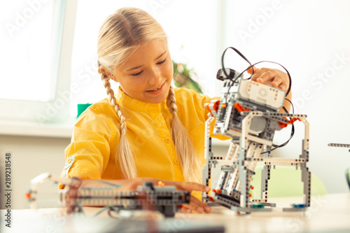 Wallpaper Mural Girl playing with a robot at science lesson. Torontodigital.ca