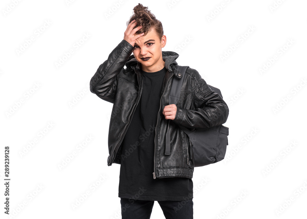 Unhappy teen boy student with backpack in style of punk goth dressed in black, isolated on white background. Upset Teenager Back to school. Sad child with spooking makeup. Unhappy teen boy student with backpack in style of punk goth dressed in black, isolated on white background. Upset Teenager Back to school. Sad child with spooking makeup.