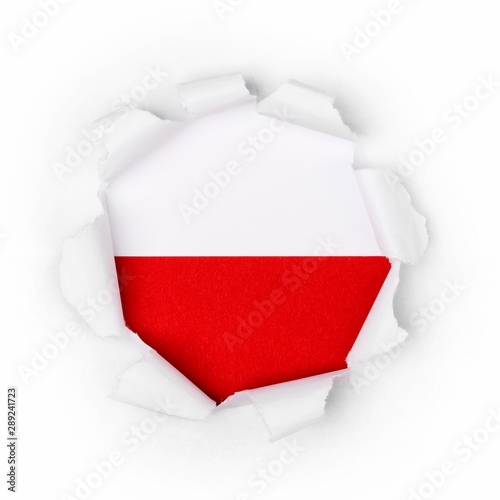 View of the polish flag through the big breakthrough in the paper.