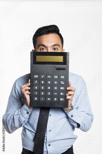 Man pointing to big calculator