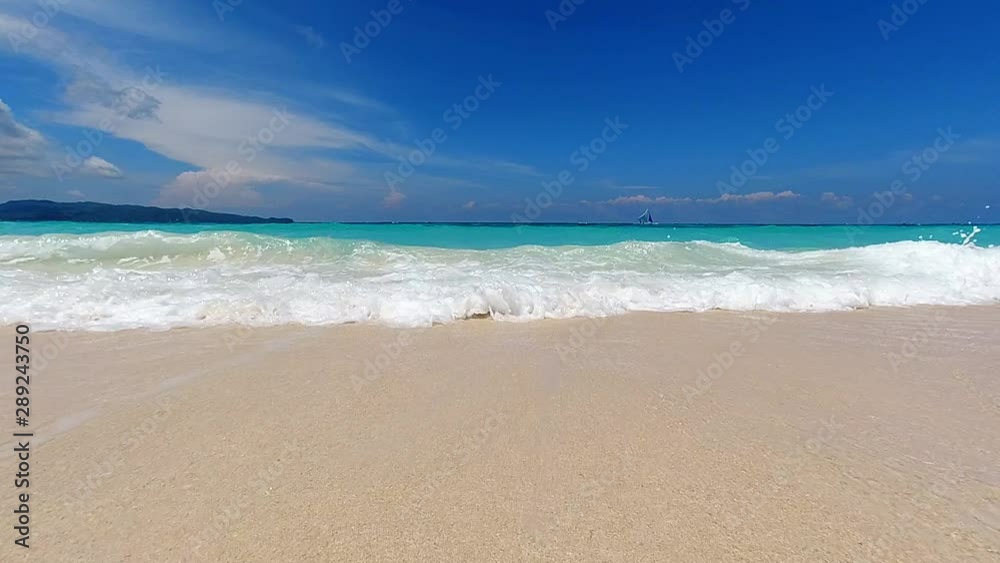 Turquoise ocean waves roll in on the sandy beach on tropical island. Ocean seascape scenic. Amazing summer travel vacation beach background. Turquoise ocean waves roll in on the sandy beach on tropical island. Ocean seascape scenic. Amazing summer travel vacation beach background.