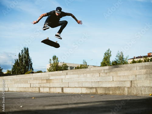 Skateboarder doing a trick on the skateboard photo