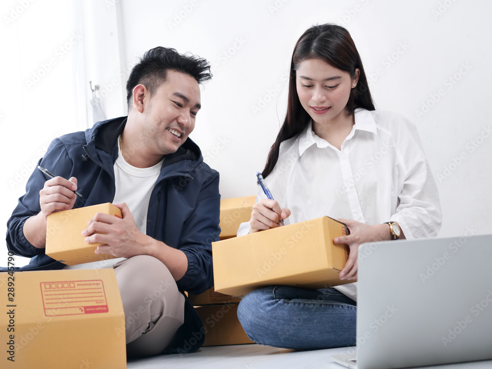 Asian couple with stack of parcel boxes, online business and delivery concept. Asian couple with stack of parcel boxes, online business and delivery concept.
