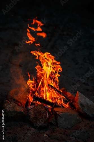 Bonfire on the sandy beach of a lake