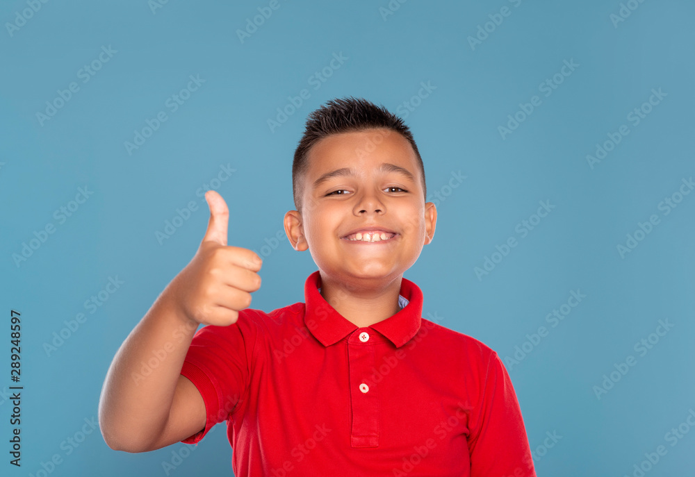 Studio shot of a young boy civing you an approving gesture, isolated on blue with copy space Studio shot of a young boy civing you an approving gesture, isolated on blue with copy space