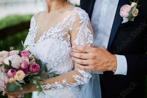 bride holds a wedding bouquet in her hands