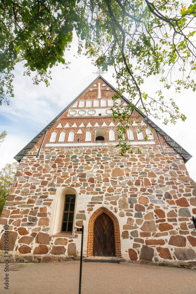 Fototapeta premium Hollola, Finland - 9 September 2019: Old medieval stone church of St. Mary in Hollola, Finland