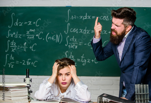 Arguing about study. Conflict situation. School conflict. Demanding lecturer. Teacher strict serious bearded man having conflict with student girl. Rebuke and punishment. You should make more efforts