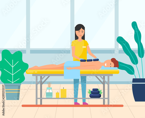 Young woman getting hot stone massage. Girl enjoying traditional body care procedure in spa salon. Professional masseuse and female patient vector. Modern office with big windows