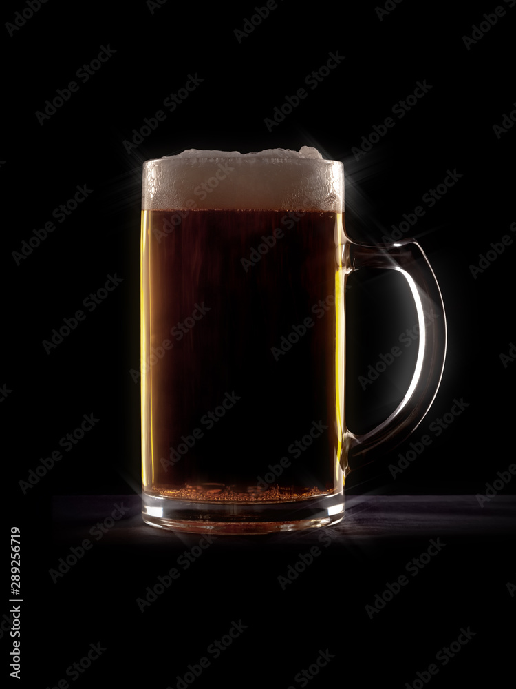 typical beer in a glass with black background typical beer in a glass with black background