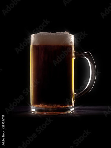 typical beer in a glass with black background