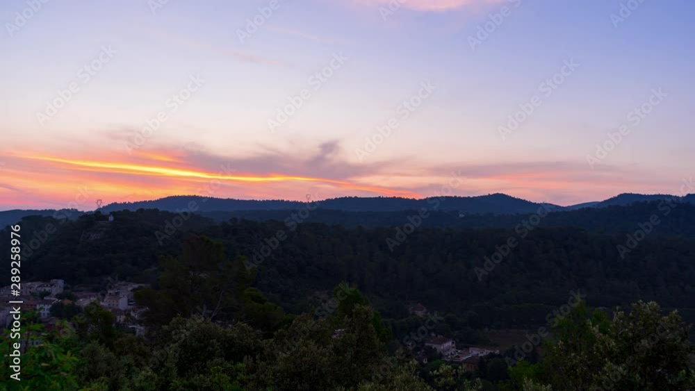 Sunrise time lapse in the summer over a valley surrounded by mountains in the Cote d'Azur region in France. Sunrise time lapse in the summer over a valley surrounded by mountains in the Cote d'Azur region in France.
