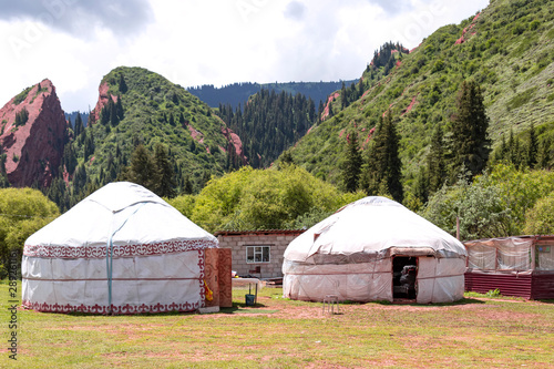 Rock Broken Heart in the Jeti-Oguz gorge Kyrgyzstan with white yurts in the foreground