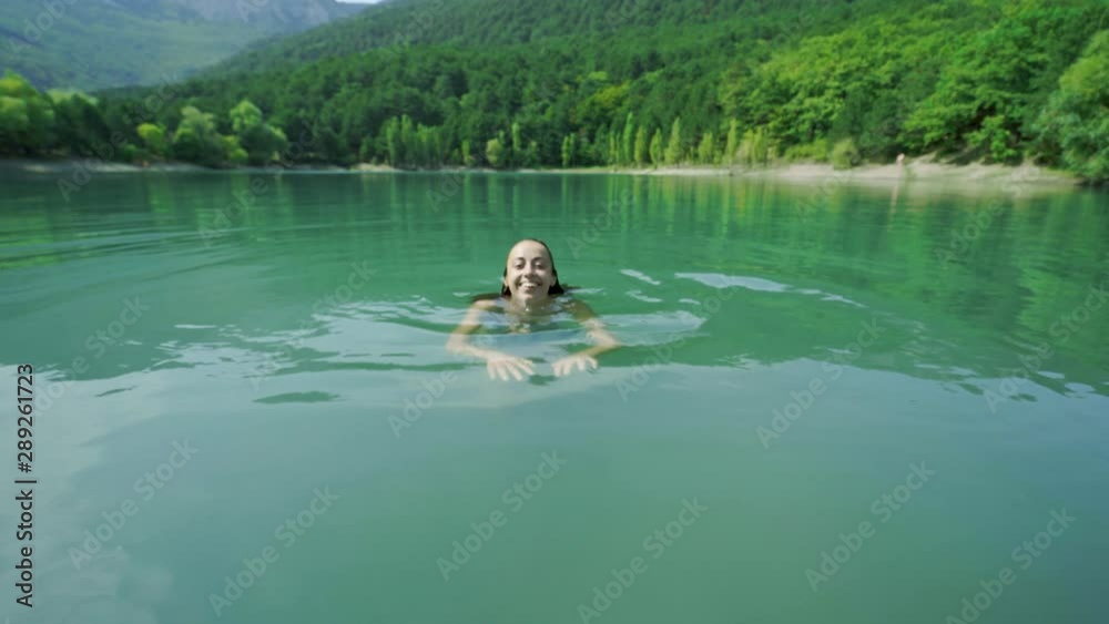 beautiful slender sexy happy woman in blue swimwear relaxing, swimming and enjoying fresh water in mountain lake at hot sunny summer day. adorable sexy sensual girl hot summer swimming relaxation beautiful slender sexy happy woman in blue swimwear relaxing, swimming and enjoying fresh water in mountain lake at hot sunny summer day. adorable sexy sensual girl hot summer swimming relaxation