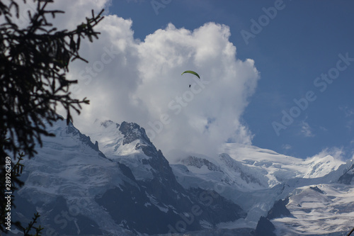 Paragliding over Mont Blanc massif in the French Alps above Chamonix