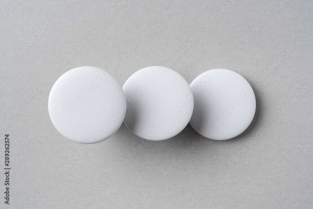 top view of white badge on grey background top view of white badge on grey background
