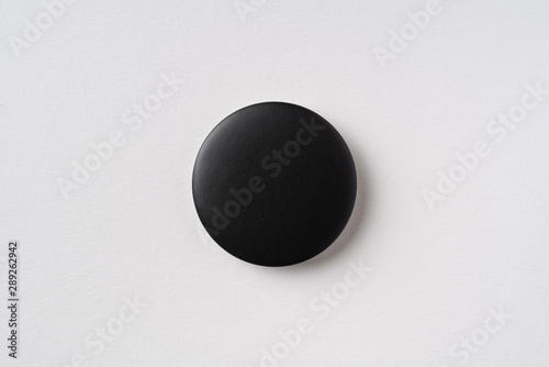 top view of black badge on grey background
