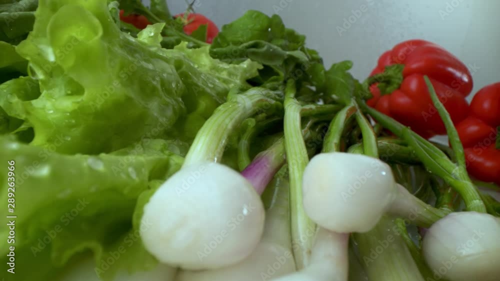 Onions and tomatoes, cucumbers, lettuce in drops of water after rinsing under running water. Onions and tomatoes, cucumbers, lettuce in drops of water after rinsing under running water.