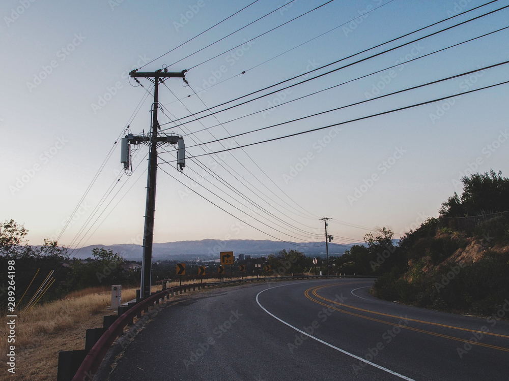 Urban hill street at Burbank with power poles Urban hill street at Burbank with power poles