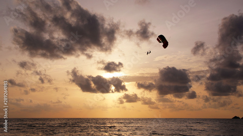 Parasailing in the sunset sky, Patong beach, Phuket, Thailand