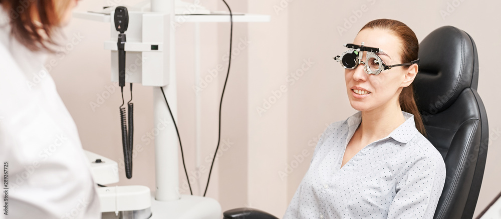 Eye ophthalmologist exam. Eyesight recovery. Astigmatism check concept. Ophthalmology diagmostic device. Beauty girl portrait in clinic - obrazy, fototapety, plakaty 