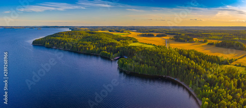 Aerial view of Pulkkilanharju Ridge, Paijanne National Park, southern part of Lake Paijanne. Landscape with drone. Blue lakes, fields and green forests from above on a sunny summer day in Finland.