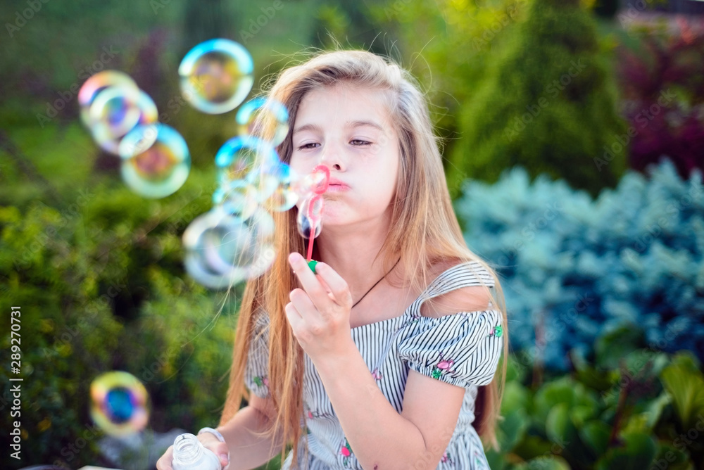 beautiful little girl child. Outdoors, blowing bubbles. Children's lifestyle beautiful little girl child. Outdoors, blowing bubbles. Children's lifestyle