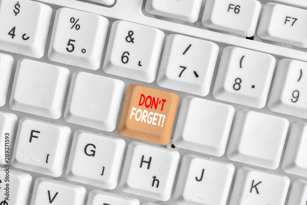 Writing note showing Don T Forget. Business concept for used to remind someone about an important fact or detail White pc keyboard with note paper above the white background Writing note showing Don T Forget. Business concept for used to remind someone about an important fact or detail White pc keyboard with note paper above the white background