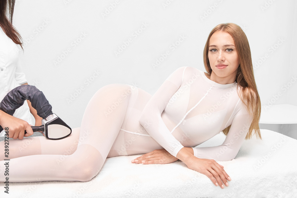 Vaccuum massage procedure. Anti cellulite lpg treatment. Cosmetology slimming. Medical device. Woman and doctor in salon. Lipo contouring Vaccuum massage procedure. Anti cellulite lpg treatment. Cosmetology slimming. Medical device. Woman and doctor in salon. Lipo contouring